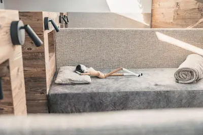 a doll laying on a bed on the stairs at La Cort My Dollhouse - Adults Only in Ortisei
