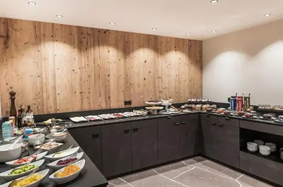 a buffet line with many plates of food at La Cort My Dollhouse - Adults Only in Ortisei