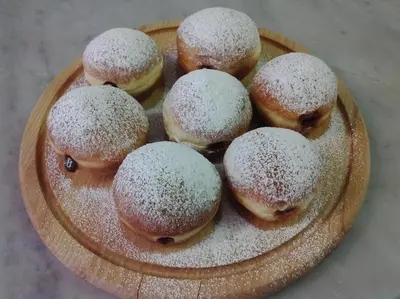 a plate of donuts with powdered sugar on it at Park Hotel Miramonti in San Martino di Castrozza