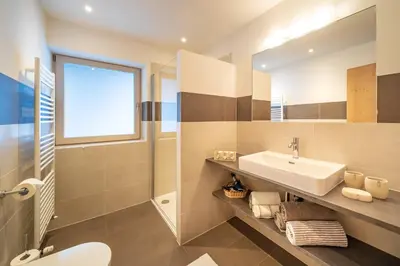 a bathroom with a sink and a mirror at Trafisolerhof in Vols am Schlern
