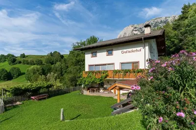 a building with a garden in front of it at Trafisolerhof in Vols am Schlern