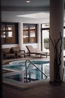 a lobby with a swimming pool in a building at Anett hotel in Vipiteno