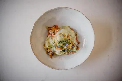 a white plate of food on a table at Anett hotel in Vipiteno