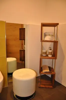 a room with a white stool in a bathroom at Gästehaus Pfuss in Caldaro