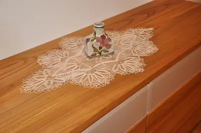 a vase sitting on top of a wooden table at Gästehaus Pfuss in Caldaro