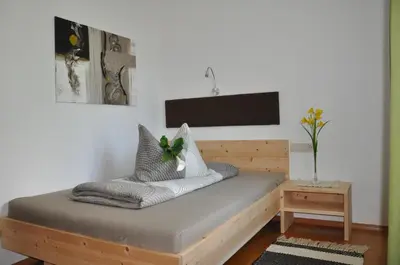 a bed with pillows on it in a room at Gästehaus Pfuss in Caldaro
