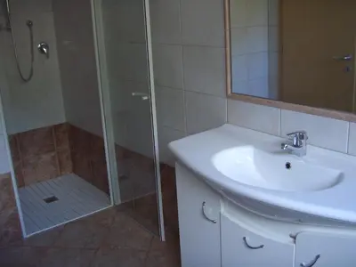 a bathroom with a glass shower and a sink at Ferienwohnung im Haus Texel V in Parcines