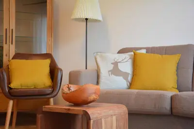 a living room with a couch and a chair at Appartement Karnutsch in Schenna
