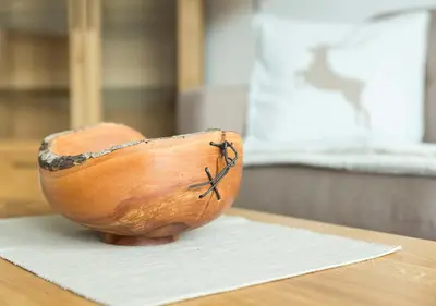 a wooden bowl sitting on top of a table at Appartement Karnutsch in Schenna