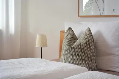 a bedroom with a bed with two pillows on it at Appartement Karnutsch in Schenna