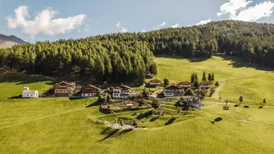 an aerial view of a house on a green hill at Taser Alm in Schenna