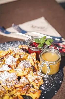 a plate of food with french fries and sauce at Taser Alm in Schenna