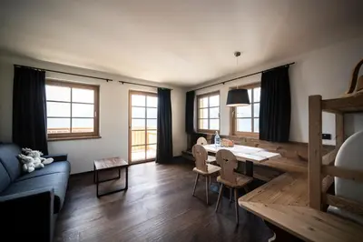 a living room with a table and a couch at Taser Alm in Schenna