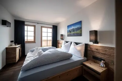 a bedroom with a large bed and a window at Taser Alm in Schenna