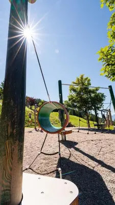 a playground with a mirror on a swing at Taser Alm in Schenna