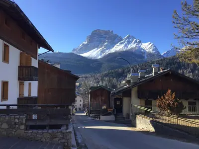 a view of a mountain from a street with buildings at Ciaseles a due passi da Cortina d'Ampezzo in San Vito di Cadore