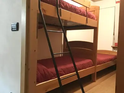 a ladder leading up to a bunk bed in a room at Ciaseles a due passi da Cortina d'Ampezzo in San Vito di Cadore