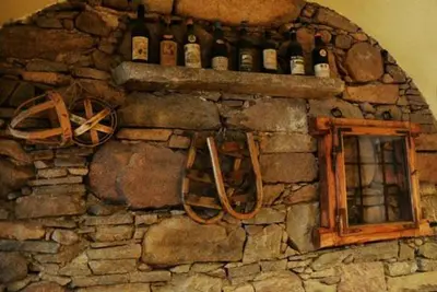 a stone wall with a bunch of bottles on it at Maso Valfloriana in Valfloriana