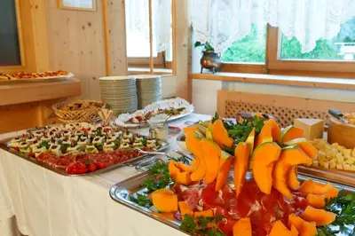 a buffet with fruits and vegetables on a table at Ciasa Roby in San Cassiano