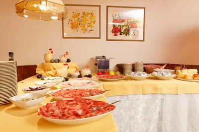 a table with many bowls of food on it at Ciasa Roby in San Cassiano