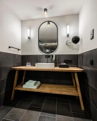 a bathroom with a sink and a mirror at Ciasa Milandura NEW SUMMER 2025 in San Cassiano