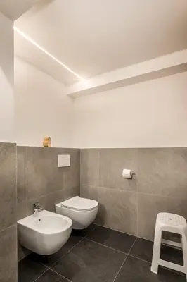 a bathroom with a white toilet and a sink at Pardellerhof Lüsen in Luson