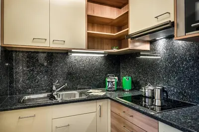 a kitchen with a sink and a counter top at Taela Apartments in San Cassiano