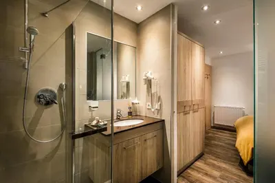 a bathroom with a sink and a shower at Taela Apartments in San Cassiano