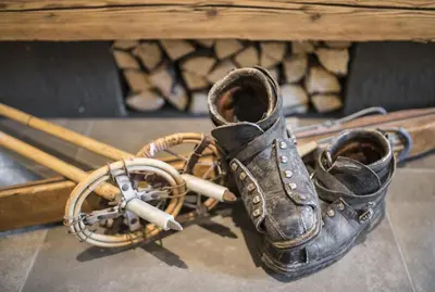 a pair of boots next to a pile of sticks at Hotel Florian in Selva di Val Gardena