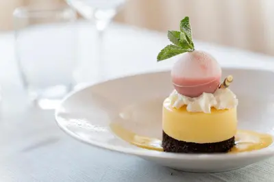 a dessert on a white plate on a table at Hotel Astoria in Canazei