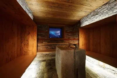 a room with a television and a wooden wall at Apartments Heidenberger Delle Scuole in Colle Isarco