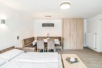 a living room with a table and a couch at Apartments Heidenberger Delle Scuole in Colle Isarco