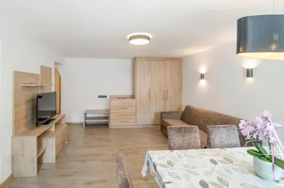 a living room with a couch and a table at Apartments Heidenberger Delle Scuole in Colle Isarco