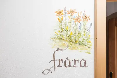 a painting of flowers on a wall at Frara Residence Apartments in San Cassiano