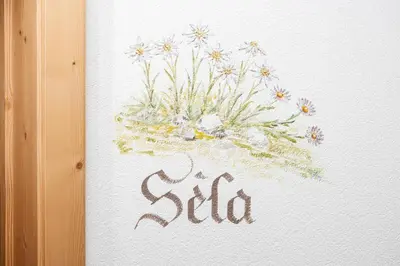 a painting of a vase of flowers on a wall at Frara Residence Apartments in San Cassiano