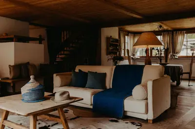 a living room with a couch and a table at CHALET D'ERT in La Valle