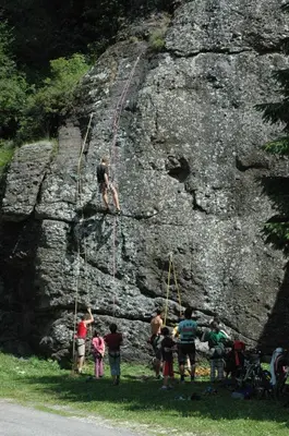 a group of people standing on a rock wall at Hotel Villa Agomer in Canazei