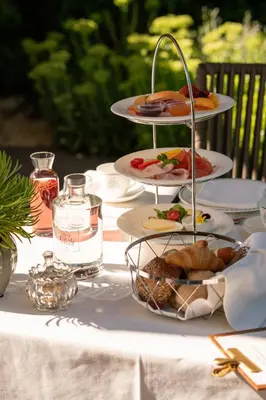a table with plates of food on top of it at Garni-Hotel Der Forsterhof in Lagundo
