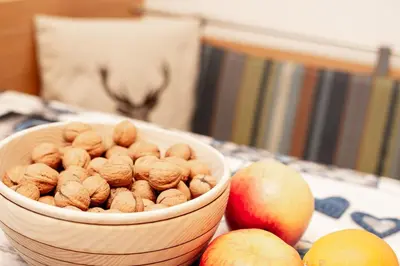a bowl of nuts and apples on a table at Haus Bergfrieden Seiser Alm Bahn in Siusi