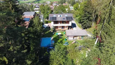 an aerial view of a house with a yard at Haus Bergfrieden Seiser Alm Bahn in Siusi