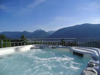 a jacuzzi tub with a view of mountains at Garni Nunnemairhof in Schenna