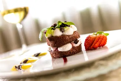 a dessert with a strawberry on a plate at Hotel La Perla Wellness & Beauty in Canazei