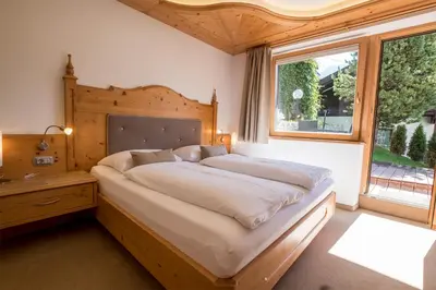 a bedroom with a large bed and a window at Garni Alba Bed & Breakfast in Ortisei