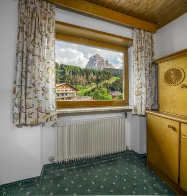 a window with a view of a mountain at Cësa Panaval Apartments in Santa Cristina in Val Gardena