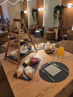 a table with a tray of food on it at Cësa Panaval Apartments in Santa Cristina in Val Gardena