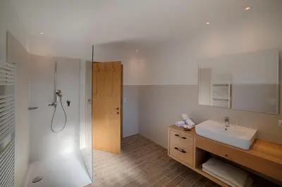 a bathroom with a sink and a shower at Hotel Kristall in Falzes