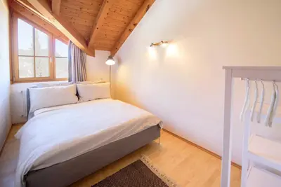 a bedroom with a bed and a window at La Vinea in Caldaro
