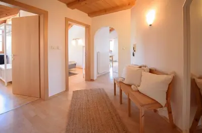 a living room with a bench and a hallway at La Vinea in Caldaro