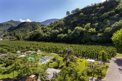 a kitchen and living room with a table and a couch at Kreuzwegerhof Nals - Historic Nature Stay with Pool near Meran & Bozen in Nalles