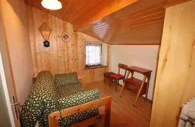 a room with a couch and a table in a house at Casa Katia in Canale dʼAgordo